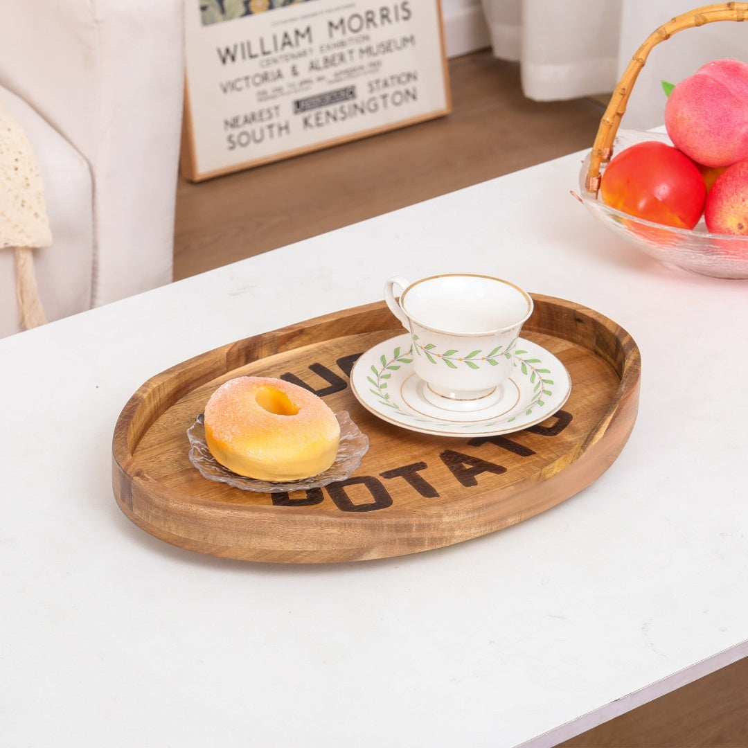 Sofa arm tray styled with drinks and snacks on a couch, demonstrating its use as a compact side table