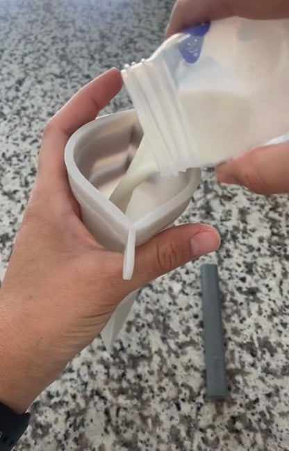 Person pouring milk into a Junobie.
