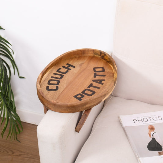 Acacia wood couch arm tray wrapped over a sofa arm, creating a stable surface for drinks and snacks