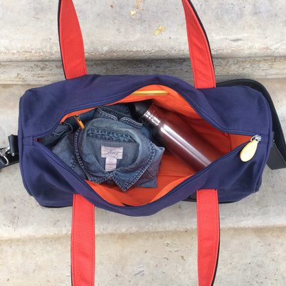 Open Dekalb duffle bag showing spacious main compartment and interior organizer pockets