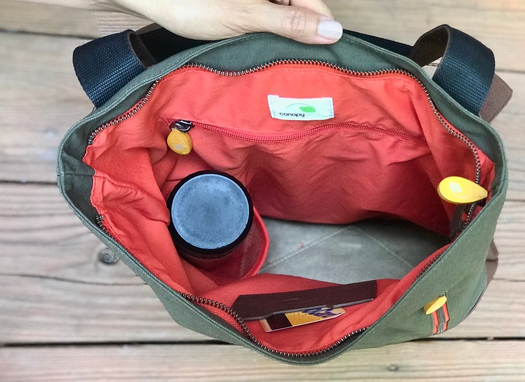 Interior of Canopy Verde 3-in-1 bag showing organized compartments, laptop sleeve and red lining