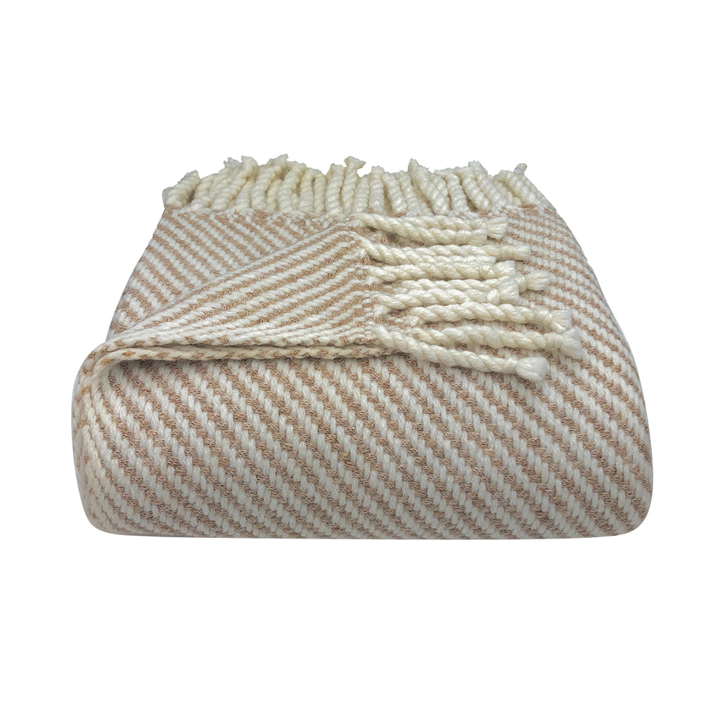 Folded beige and white striped blanket with tassels on a white background