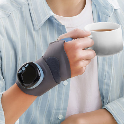 Person holding a coffee mug while wearing the lightweight Pursonic EMS wrist massager, showing comfortable everyday use.